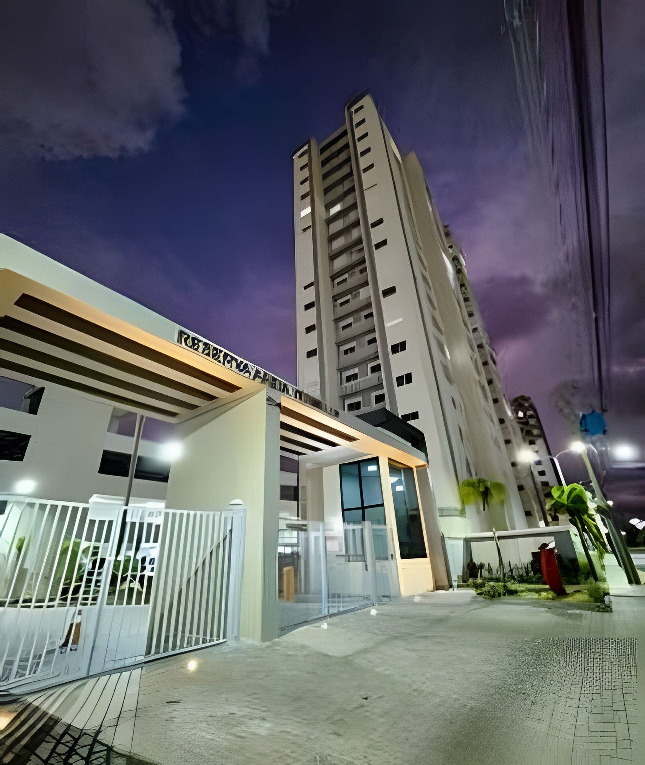 A modern building with a flat roof and a large entrance.