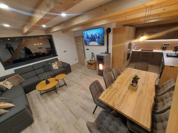 A modern living room with a sofa, coffee table, and TV.