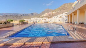 A swimming pool with a view of a hillside town.