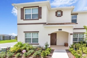 A two-story residential building with a front entrance, a small porch, and a number '8920' above the door. - Luxury 5 Bdrm Championsgate Pool, Water Park, Bbq (Davenport)