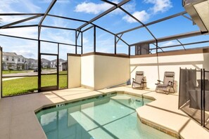 A covered outdoor swimming pool with a view of residential buildings. - Luxury 5 Bdrm Championsgate Pool, Water Park, Bbq (Davenport)