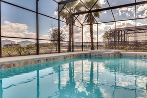 A swimming pool with a clear view of the surrounding landscape, including palm trees and distant buildings. - Bella Blue at Bella Vida Resort (Kissimmee)