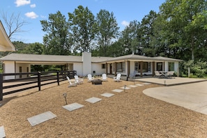 A two-story house with a covered patio area, outdoor seating, and a fire pit. - Your Franklin Oasis (Franklin)