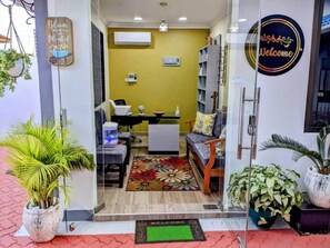 A reception area with a sofa, a small table, and a chair. There is a 'Welcome' sign on the wall. - The Lavish suite with Sunset view @Arikays homes (Dar es Salaam)