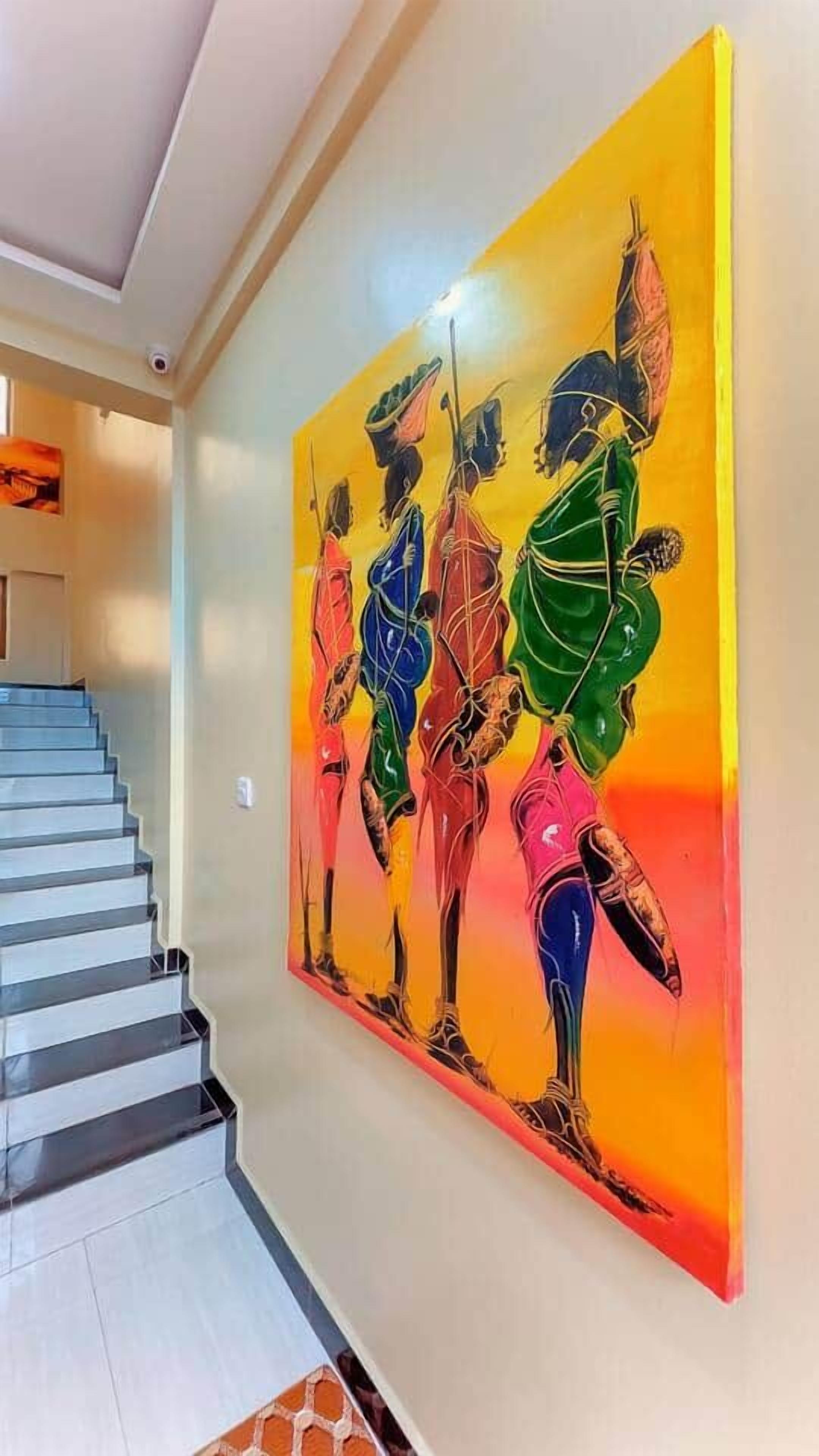 A staircase leading to a room with a large abstract painting on the wall.