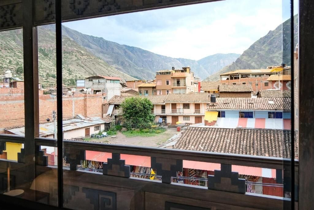 A view of a mountainous village with traditional buildings and a clear sky.