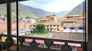 A view of a mountainous village with traditional buildings and a clear sky.