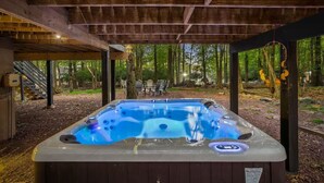 A hot tub under a wooden pergola in a wooded area with outdoor seating. - Honky Tonk Karaoke! Hot Tub - Sauna - 5 min wlk 2 lake (Lake Harmony)