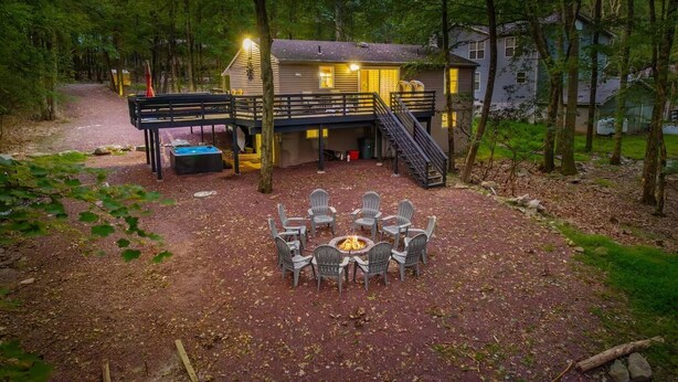A cabin with a deck, outdoor seating, and a fire pit. - Honky Tonk Karaoke! Hot Tub - Sauna - 5 min wlk 2 lake (Lake Harmony)