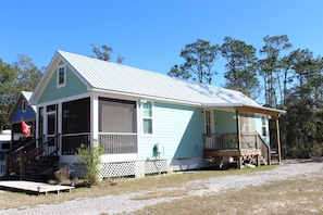 A single-story house with a porch, a covered front porch area, and a small front yard.