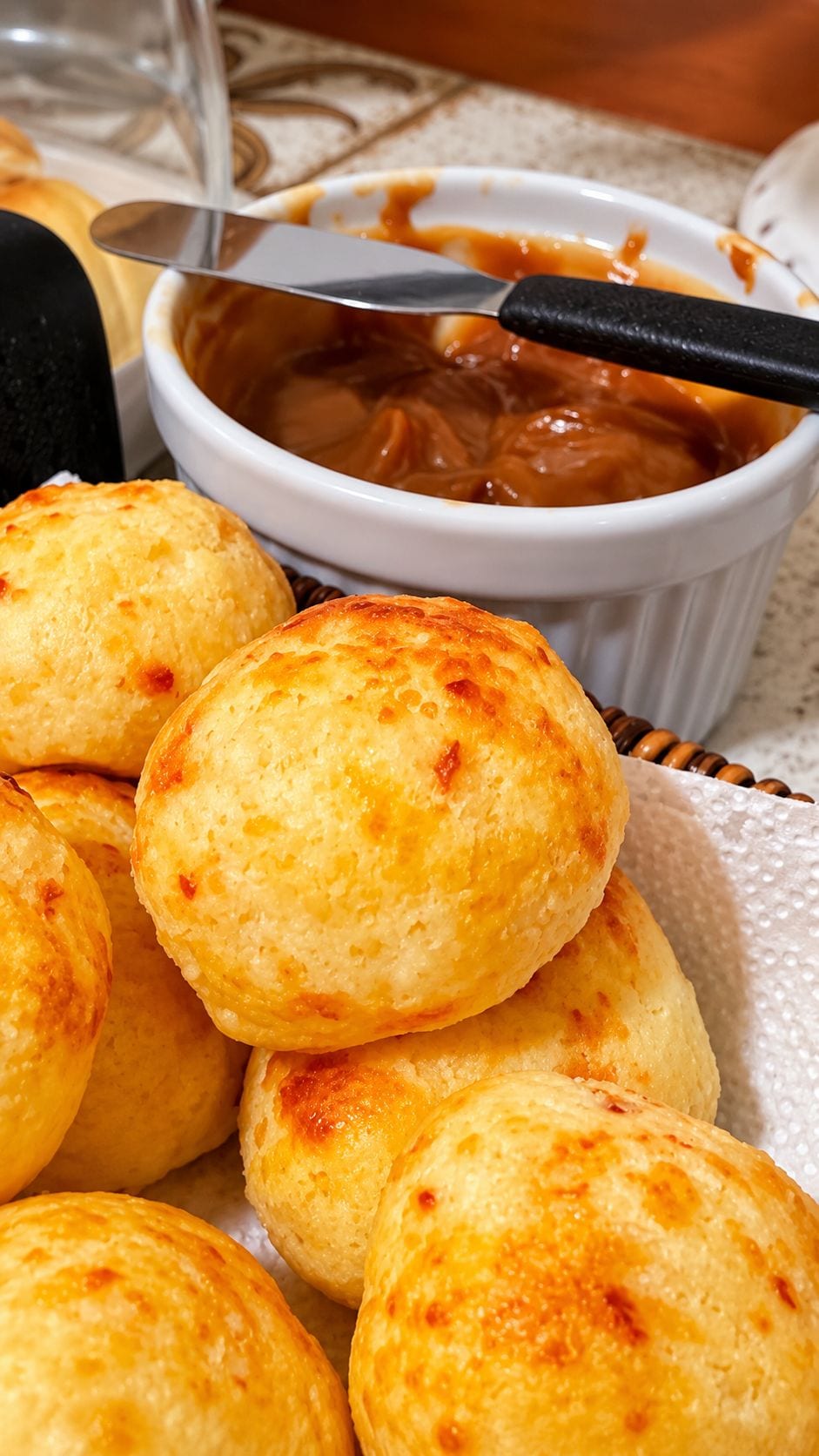 A bowl of cheese curds with a knife, and a basket of cheese curds.