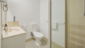 A bathroom with a toilet, sink, and shower area. - Affordable townhouse Retreat| Pool| Prime Location (Eight Mile Plains)