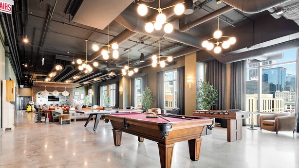 A billiards room with multiple tables, large windows, and a high ceiling with exposed ductwork. - Wabash 4BR - Pool, Free In & Out Parking 1 (Chicago)