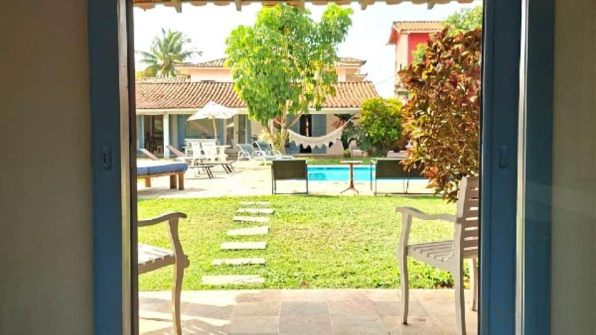 A view of a pool area with lounge chairs and a hammock.