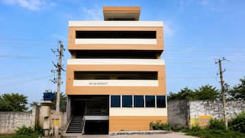 A multi-story building with a sign reading 'SRI SAI REGENCY'.