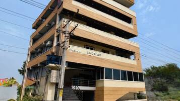 A multi-story building with a staircase leading to the entrance.
