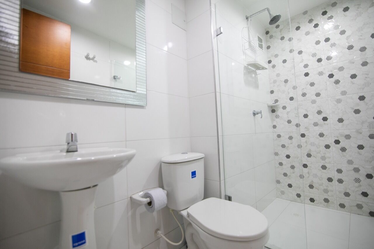 A bathroom with a sink, toilet, and shower.