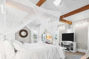 A bedroom with a bed, a TV, and a white canopy. - Private Estate | Historic Home + Industrial Studio (Uniontown)