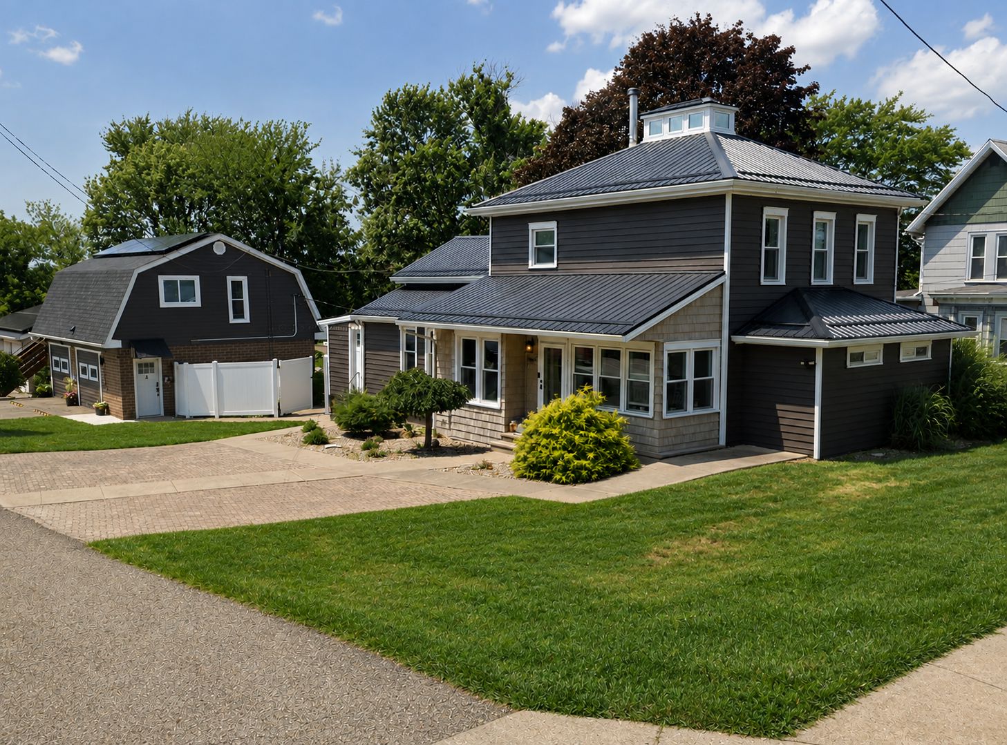 A two-story residential house with a garage, a covered porch, and a well-maintained lawn.