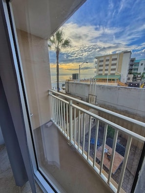 A balcony with a view of a beach and buildings. - NEW Amazing Ocean View Studio in Daytona Beach! (Daytona Beach)