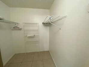 A small, enclosed laundry area with a metal drying rack and a wall-mounted shelf. - 2-bedroom in Bradenton close to IMG and beach . (Bradenton)