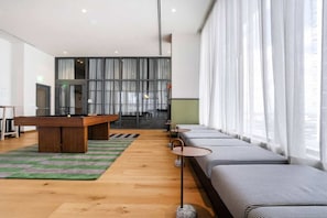 A modern living room with a pool table, a sofa set, and a dining area. - The Crosby Miami Studio by Palermo Home (Miami)