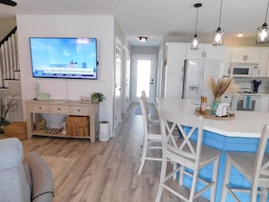 A modern kitchen with white cabinets, a built-in microwave, and pendant lights. - Ocean Lakes 1576 Spacious 4BR with Hot Tub & Golf Cart (Myrtle Beach)