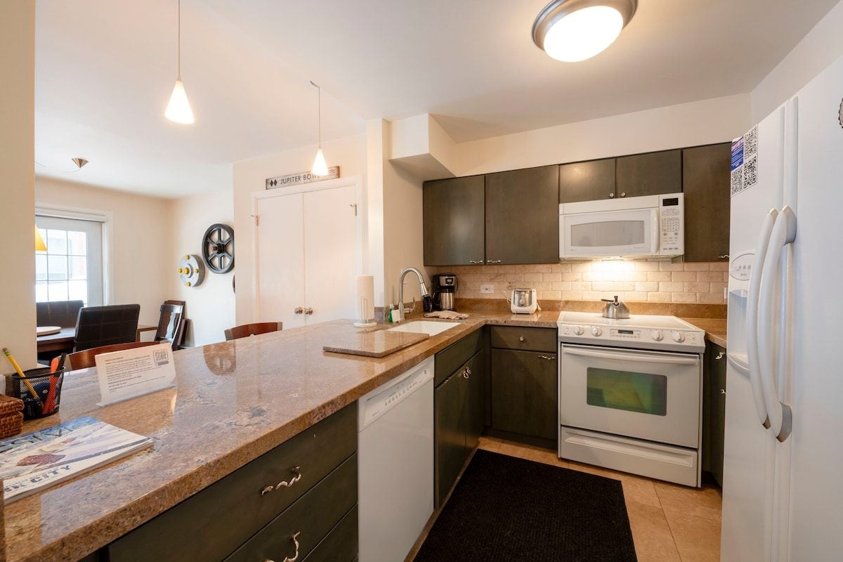 A modern kitchen with a built-in microwave, oven, and refrigerator.