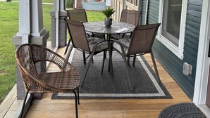 A covered porch with a table and chairs, a fan, and a view of the backyard. - The Fox Den in delightful Columbia (Columbia)