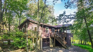 A two-story wooden cabin with a covered porch and a staircase leading to the upper level. - Best Of Both Lakes Wally/WLE-3 Bed/2 Bath, Kayaks included. (Lake Ariel)