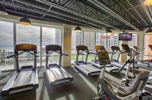 A gym with treadmills, elliptical machines, and weight equipment. - Laketown Wharf 316 (Panama City Beach)