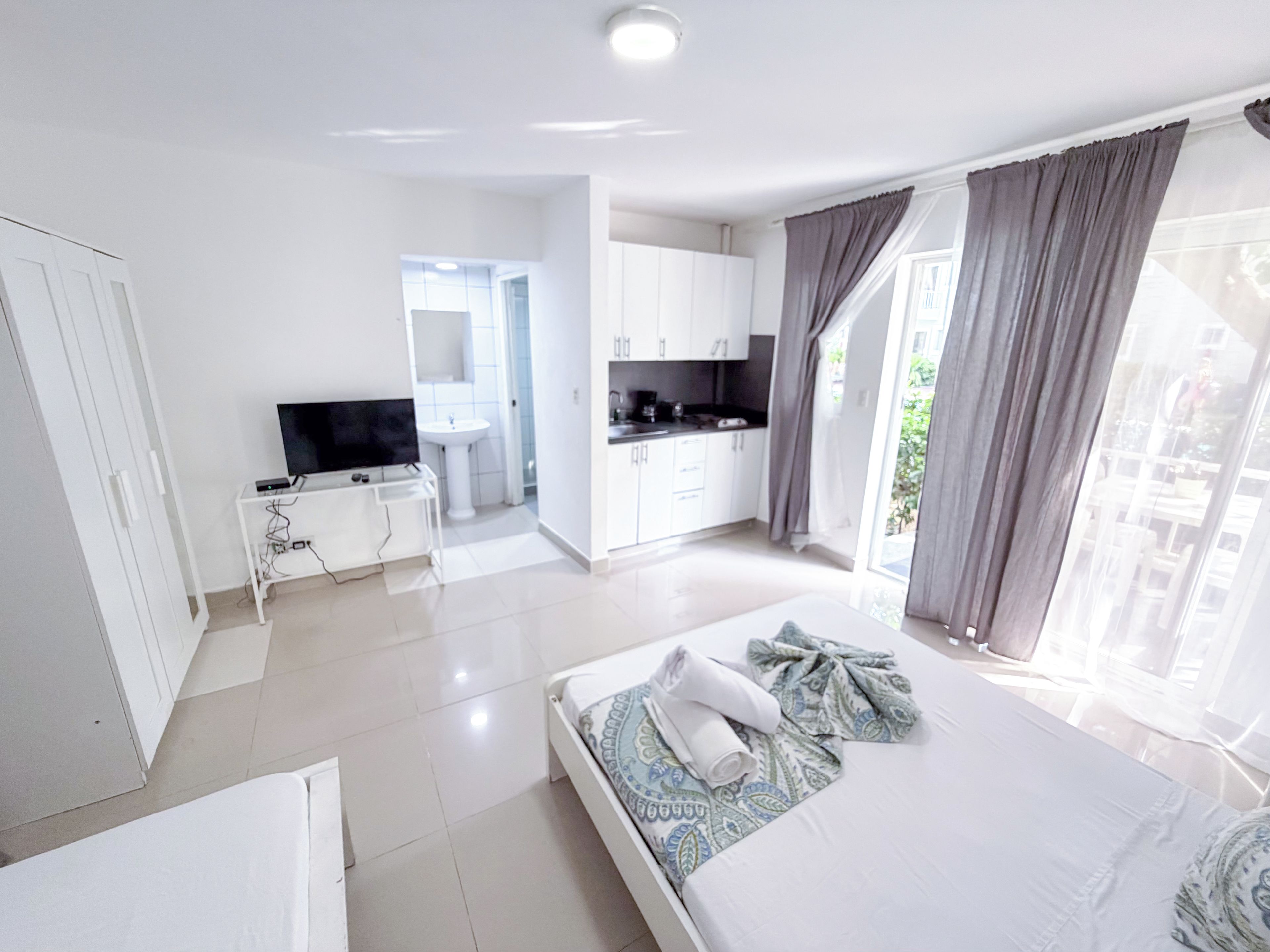 Deluxe Studio, Pool View | Iron/ironing board, bed sheets