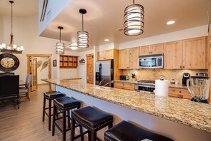 A modern kitchen with granite countertops, stainless steel appliances, and wooden cabinets. - AL4303 | Gorgeous Top Floor Condo | Close to Skiing | Air Chilling | Hot Tubs (Steamboat Springs)