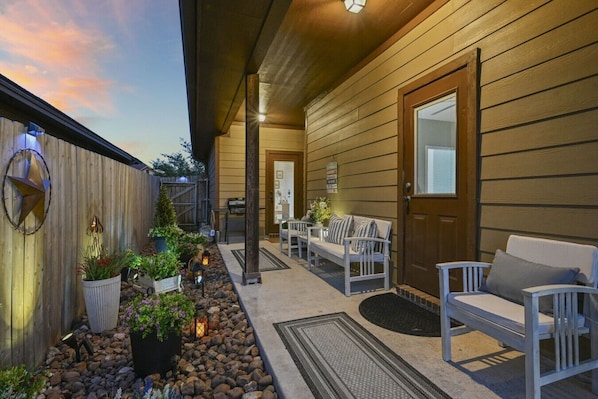 A wooden exterior with a porch, outdoor seating, and a decorative star.