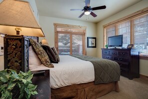 A bedroom with a bed, a dresser, a television, and a ceiling fan. - BL6106 | Mountain Residence | Private Patio with Hot Tub | Air Chilling (Steamboat Springs)