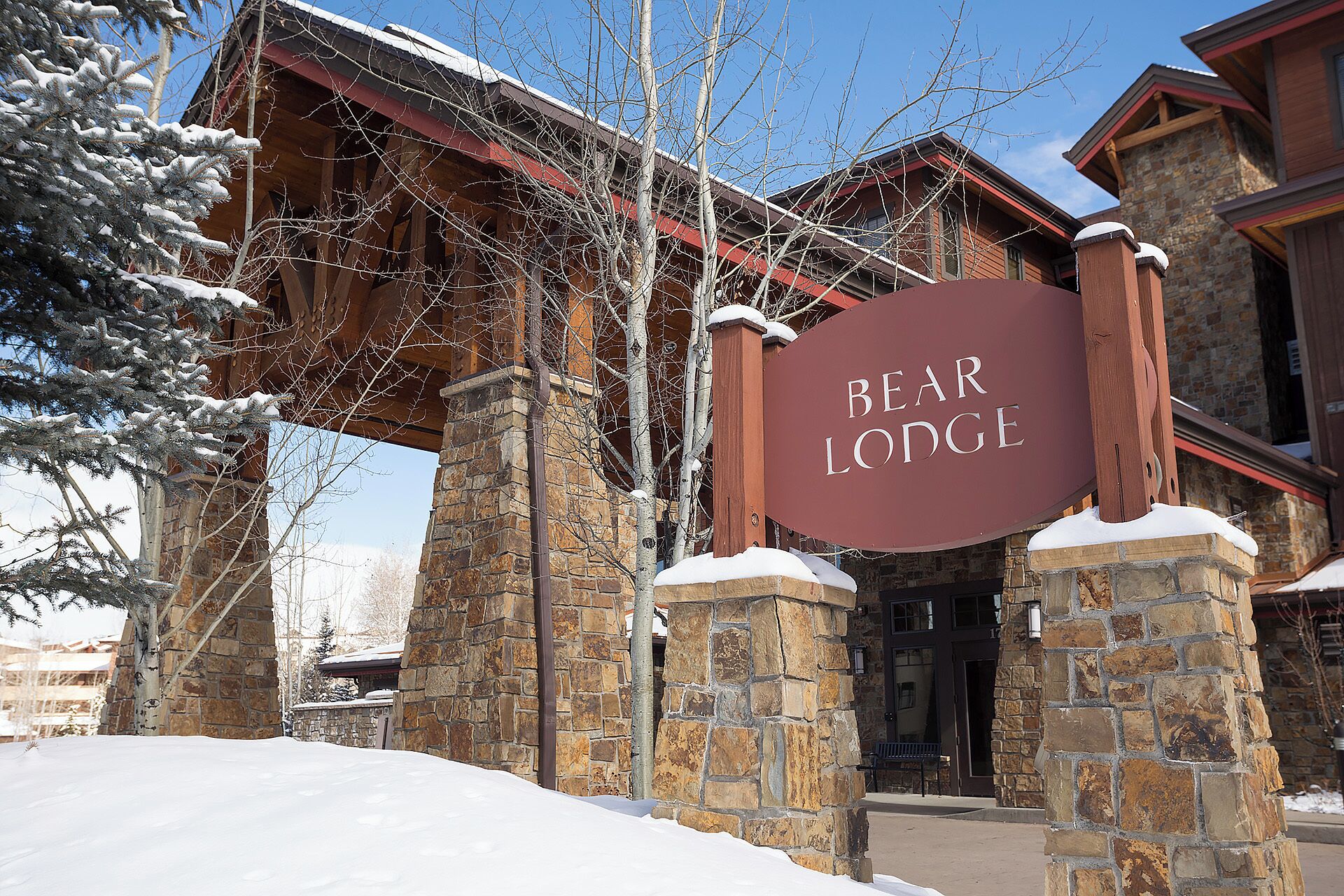A stone building with a sign reading "Bear Lodge."