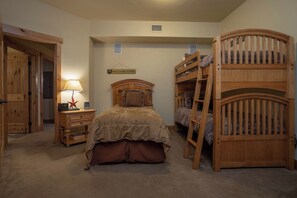 A bedroom with a bunk bed, a single bed, a nightstand, a lamp, and a sign on the wall. - BL6209 | Mountain Views | 4 Pools | 10 Hot Tubs | Air Chilling | Close to Mtn (Steamboat Springs)
