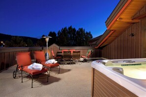 An outdoor patio with lounge chairs, a hot tub, and a table. - BL6304 | Private Roof Top with Hot Tub | Stunning Condo | Air Chilling | Pools (Steamboat Springs)