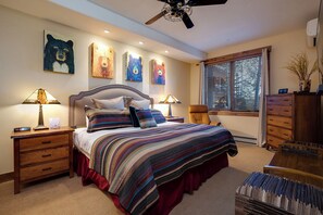 A bedroom with a large bed, two bedside tables, a ceiling fan, and artwork on the walls. - CL3110 | Gorgeous Mountain Home with Updates | A/C | Close to Skiing (Steamboat Springs)