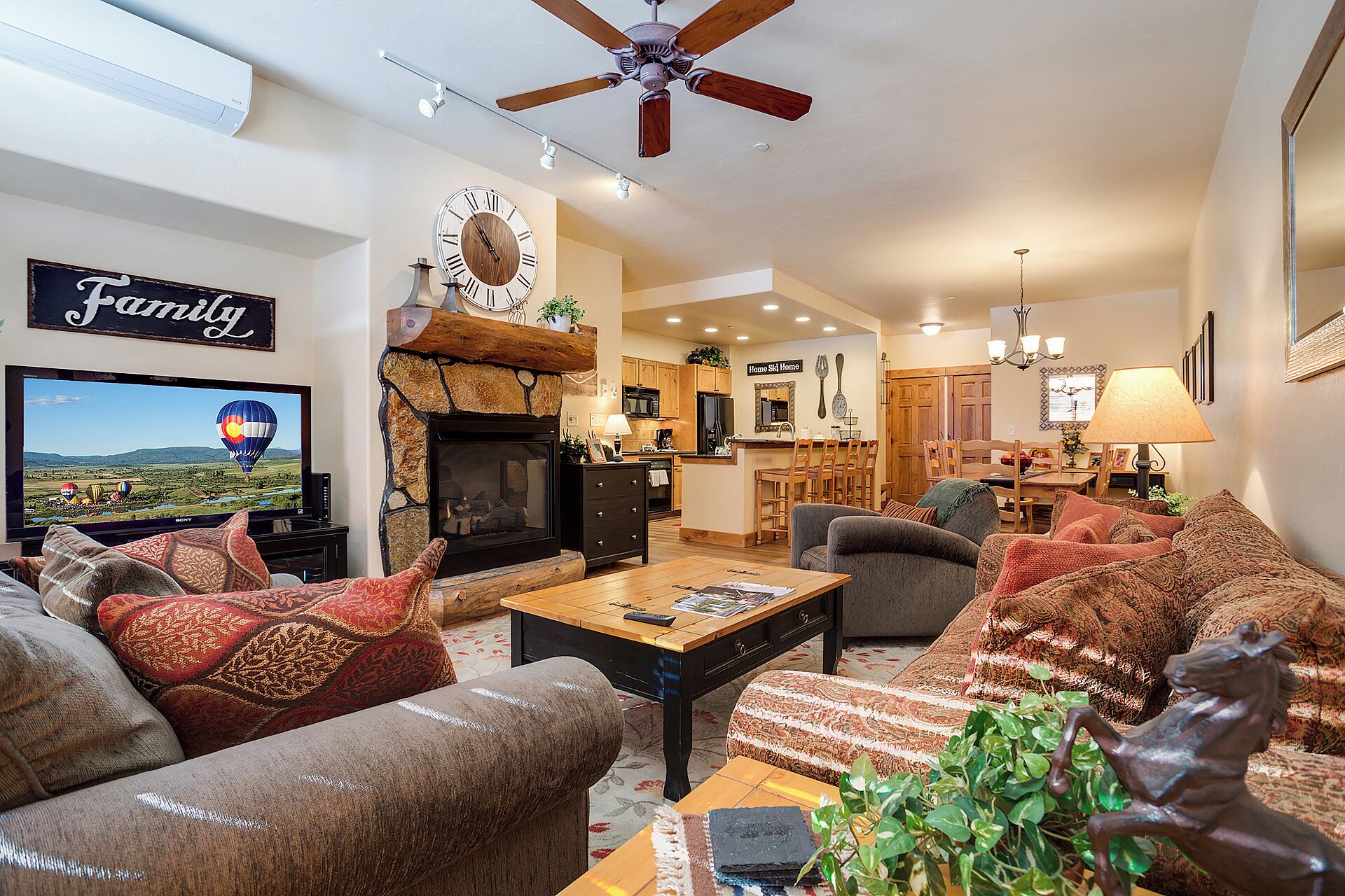 A living room with a fireplace, a television, and a sign that reads 'Family'.