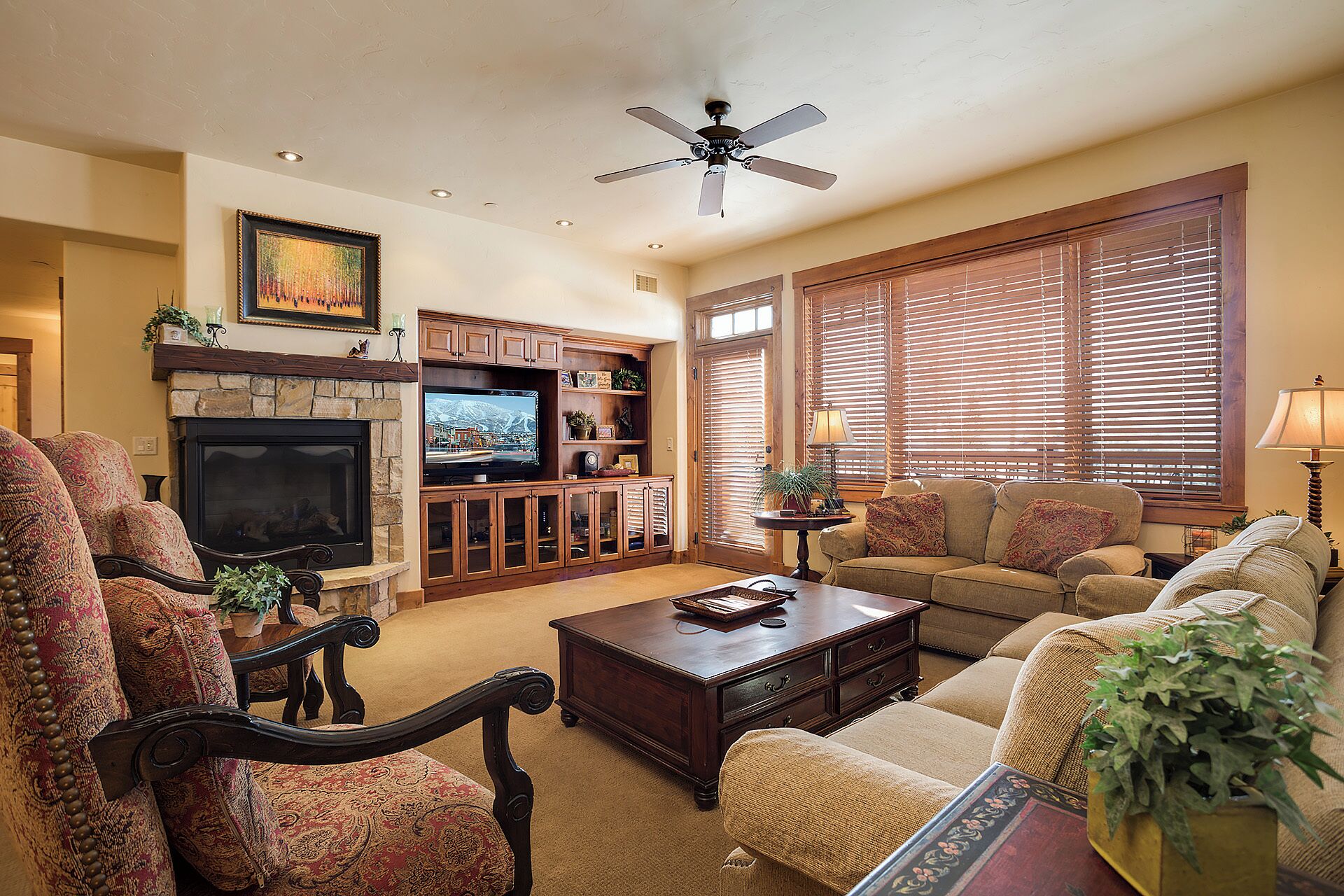 A living room with a fireplace, television, and comfortable seating.