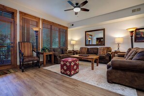 A living room with a wooden floor, two sofas, a coffee table, and a ceiling fan. - EL5106 | Enough room for Everyone | Air Chilling | Short Walk to Mtn (Steamboat Springs)