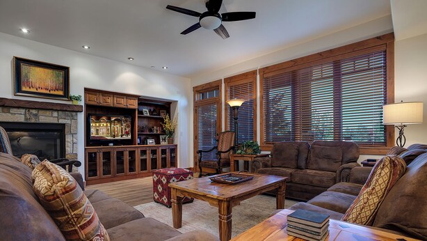 A cozy living room with a fireplace, wooden furniture, and large windows with blinds. - EL5106 | Enough room for Everyone | Air Chilling | Short Walk to Mtn (Steamboat Springs)