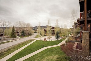 A residential area with a road, green lawns, and buildings with balconies. - EL5106 | Enough room for Everyone | Air Chilling | Short Walk to Mtn (Steamboat Springs)