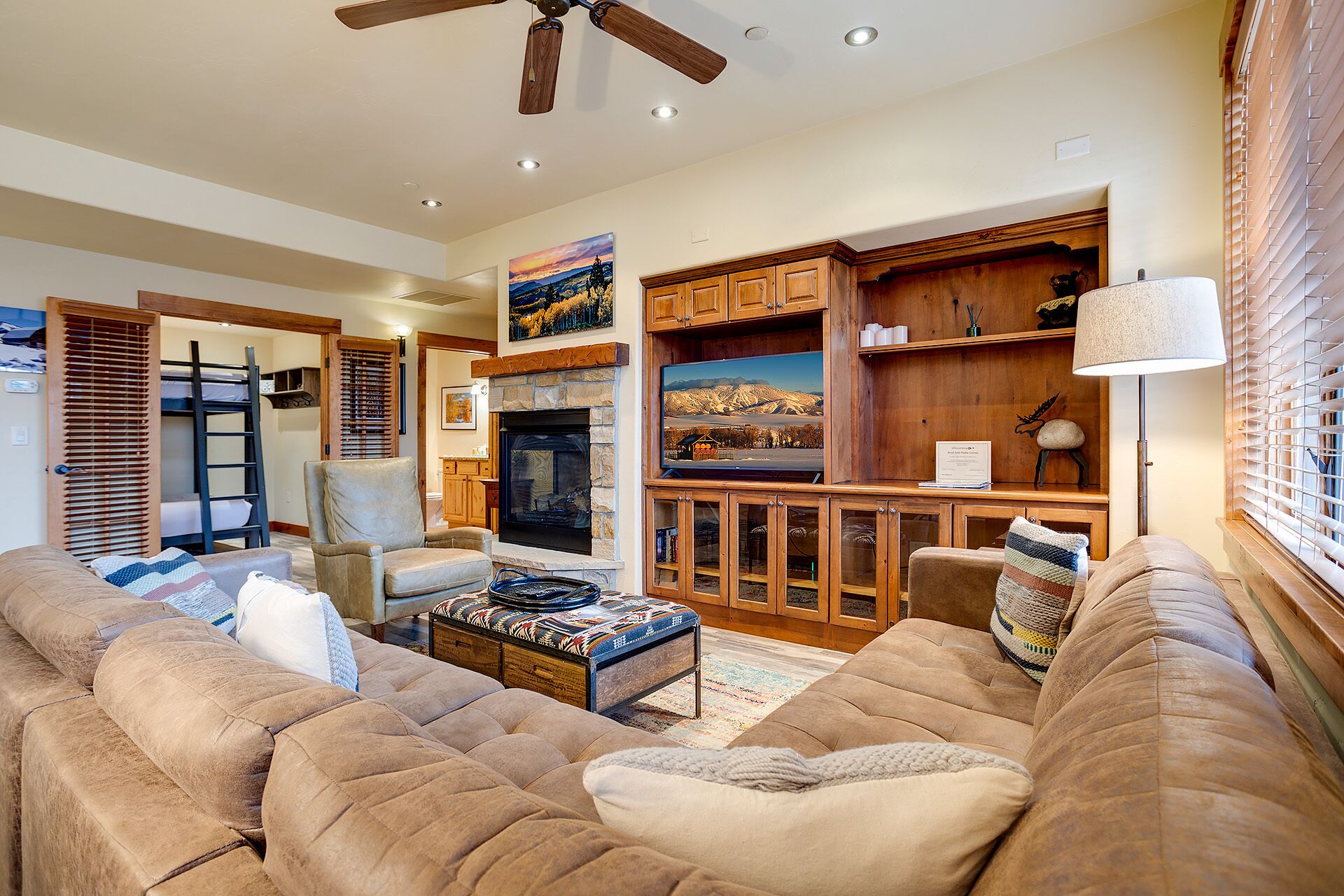 A cozy living room with a fireplace, comfortable seating, and a television.