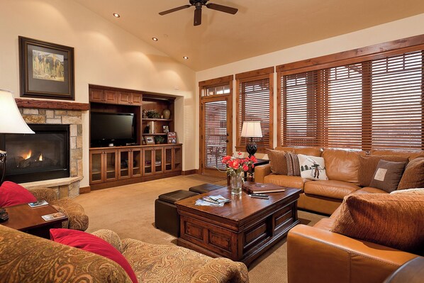 A living room with a fireplace, television, and comfortable seating. - EL5206 | Relax in Luxury | Spacious and Amenities Galore | Air Chilling | Pool (Steamboat Springs)