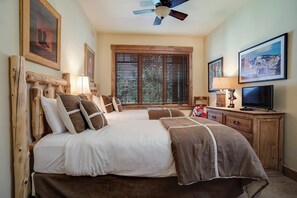 A bedroom with a bed, a desk, a television, and a ceiling fan. - EL5207 | Short Walk to Mtn| Air Chilling | 10 Hot Tubs| 4 Pools (Steamboat Springs)