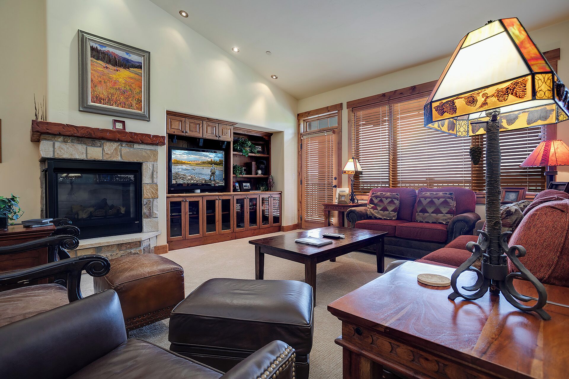 A cozy living room with a fireplace, comfortable seating, and a television.