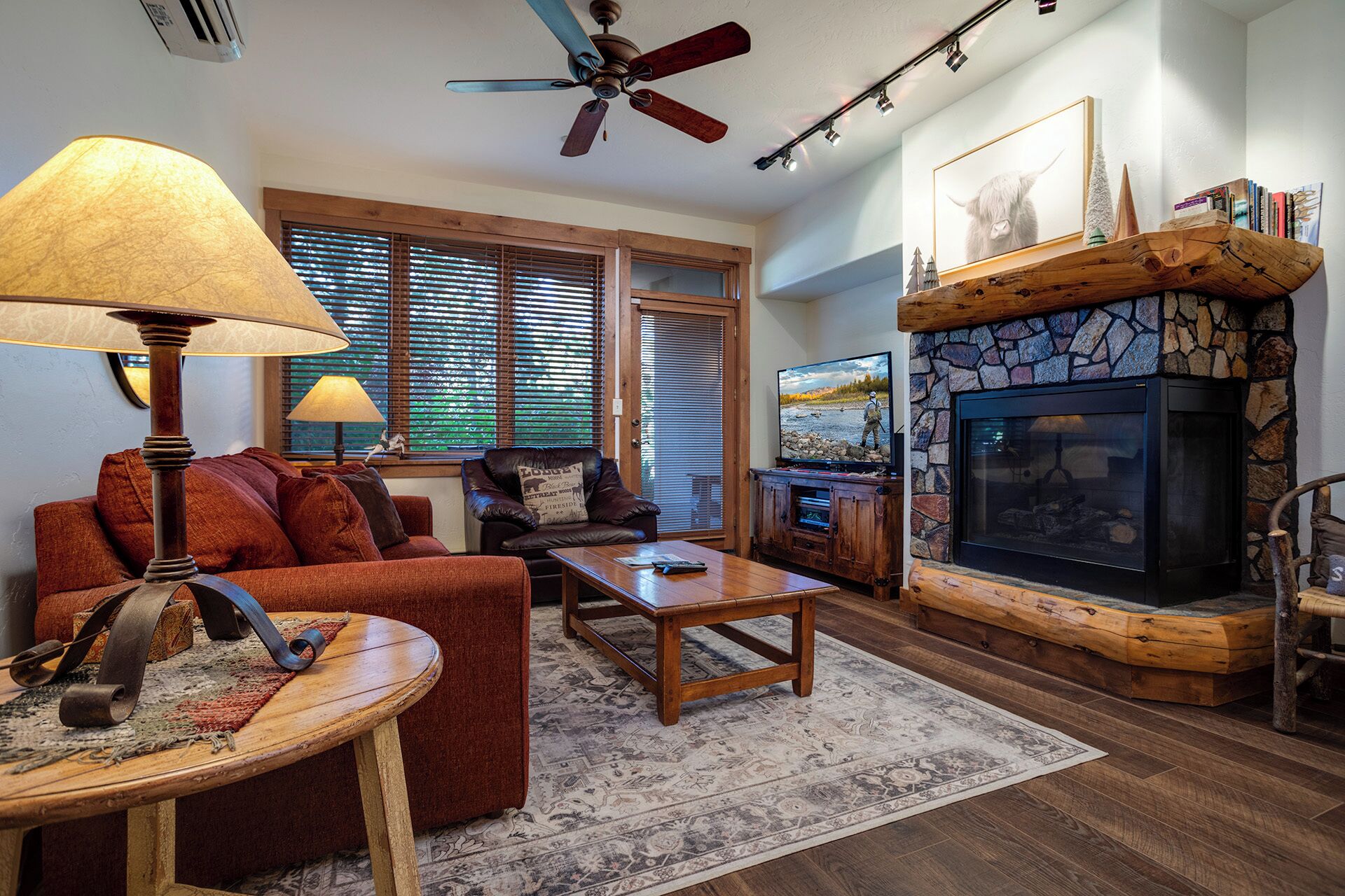 A cozy living room with a fireplace, a television, and comfortable seating.