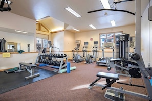 A gym with various exercise equipment, including treadmills, dumbbells, and weight machines. - TL2207 | Lovely Residence | Pools | Close to Slopes | Winter Shuttle (Steamboat Springs)